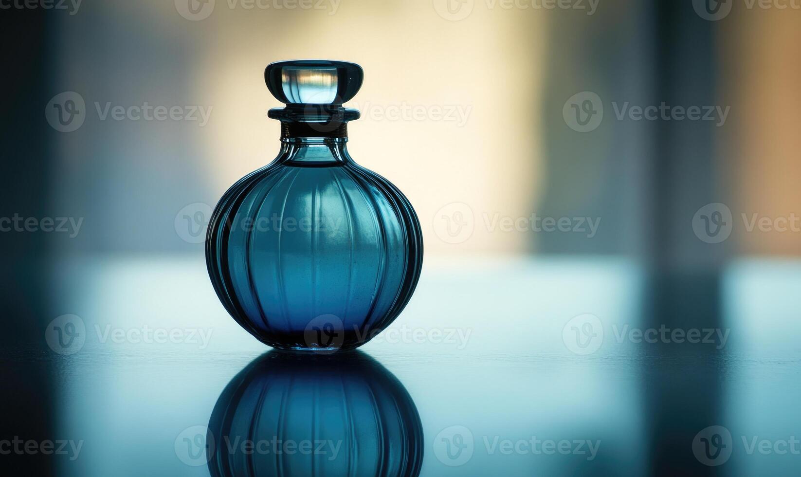A blue perfume bottle with a blue lid photo