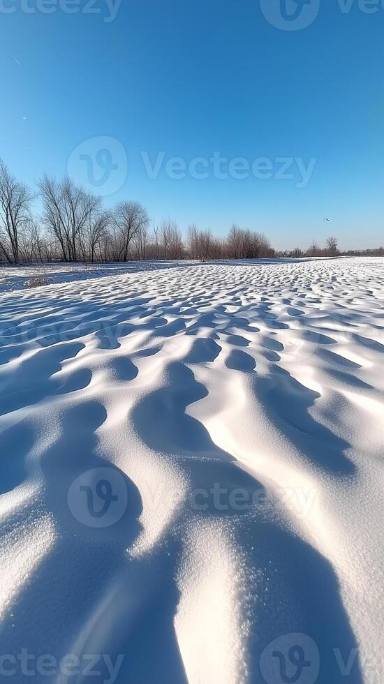 Snow drifts form waves across the open field , wallpaper art photo