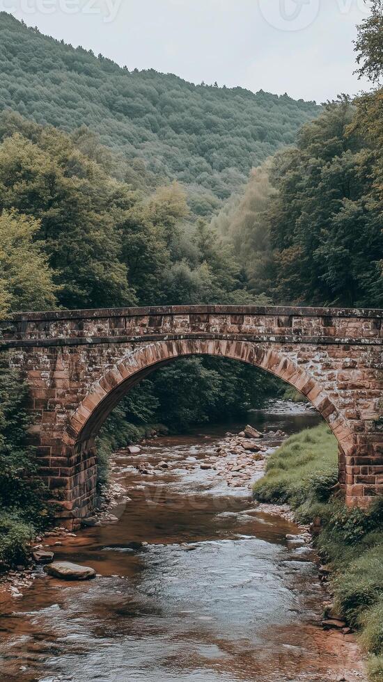 Stone bridge spanning stream between rolling hills , photorealistic photo