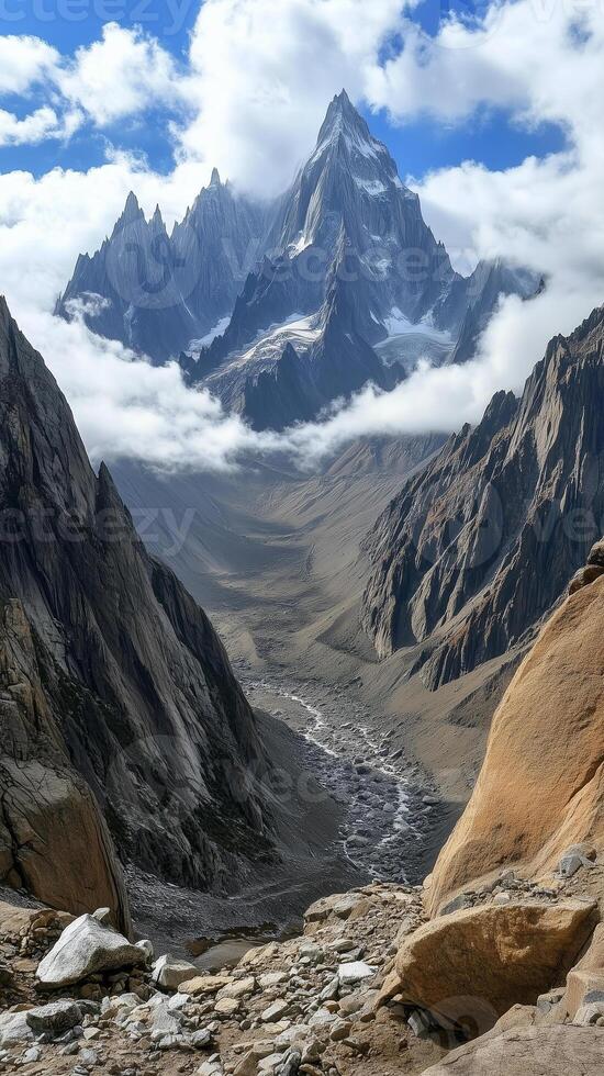 Peaks rise through cloud layers toward the sky in a mountain range, wallpaper art photo