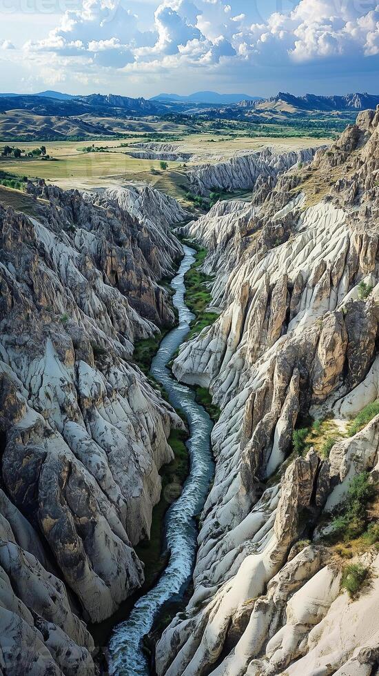 Rivers wind through valleys between rock formations into a distant horizon, photorealistic wallpaper photo