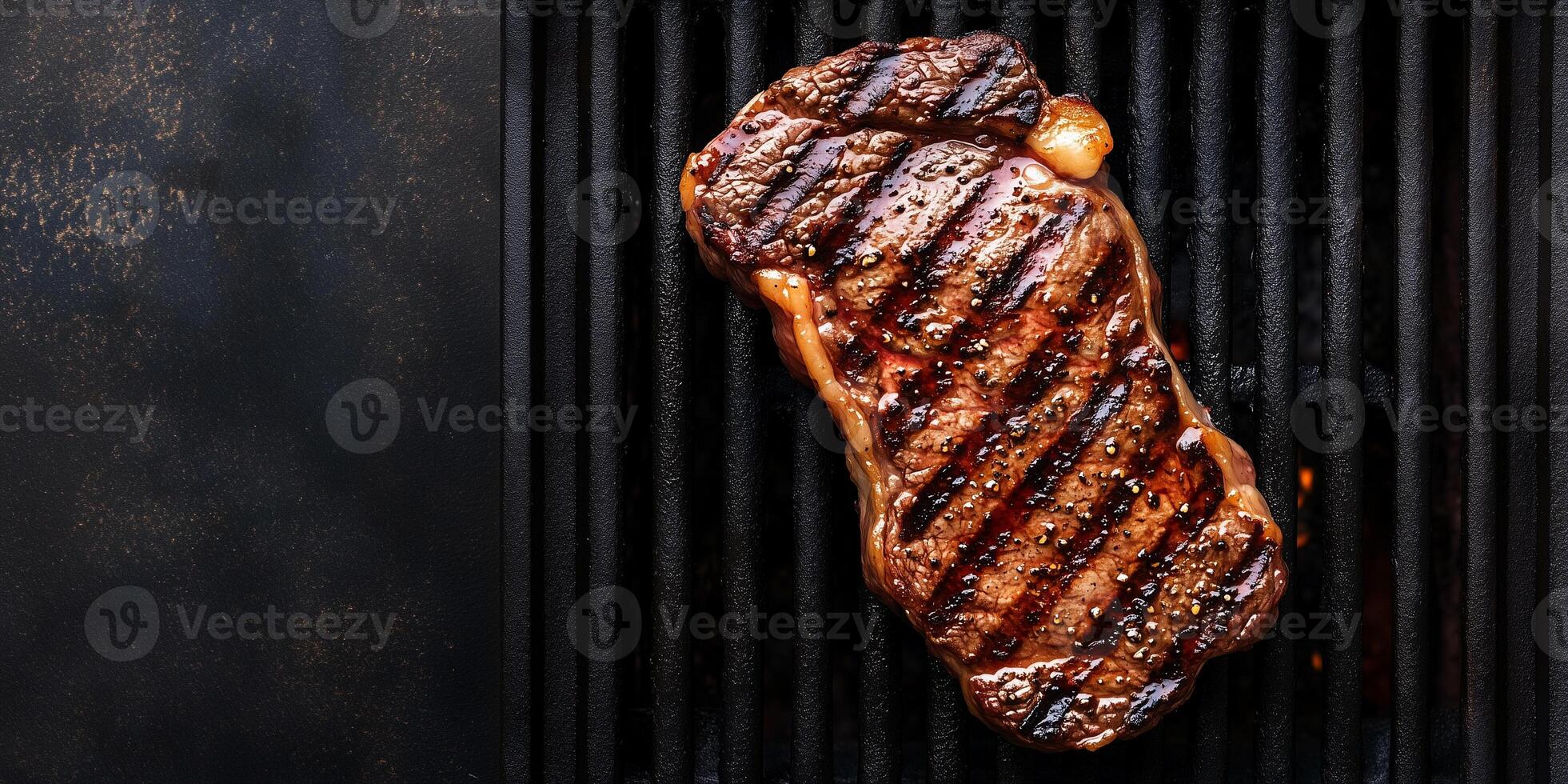 Close-up of ribeye steak with grill marks and fat edges on a grill, food setting photo
