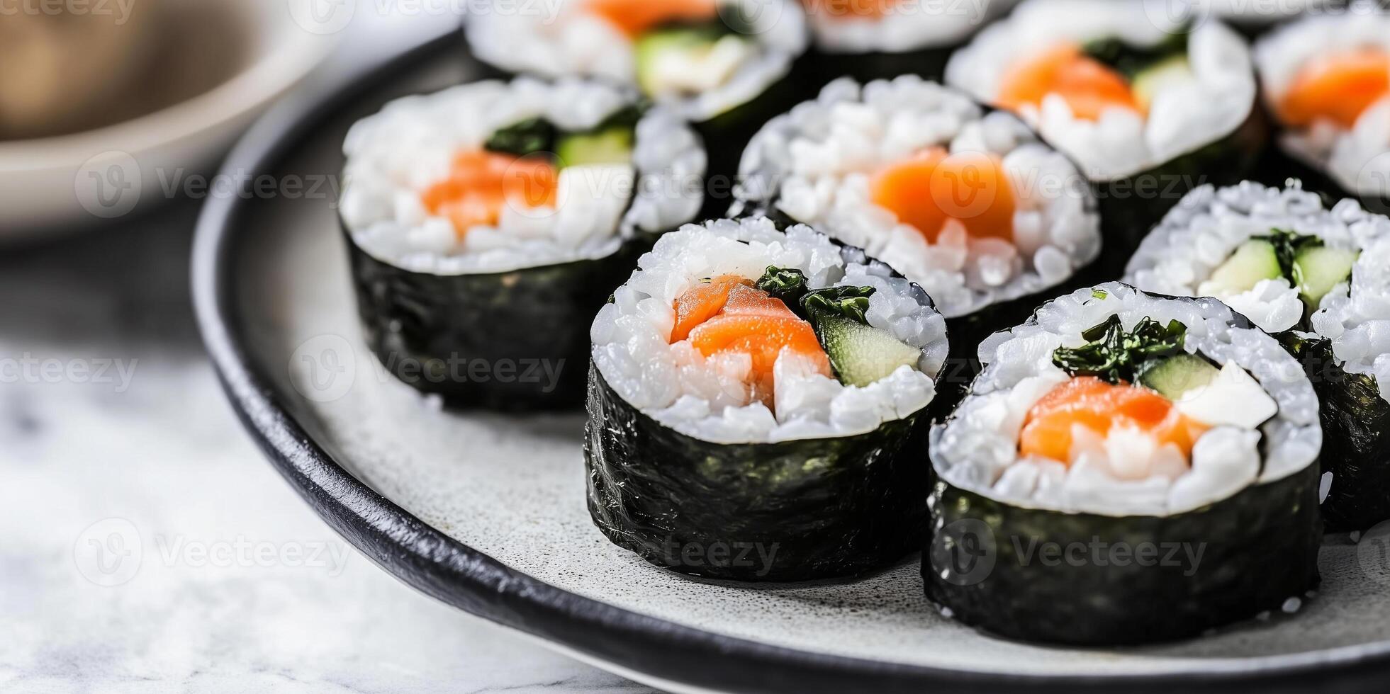 Sushi rolls sliced on a serving platter with visible seaweed and rice, food setting photo