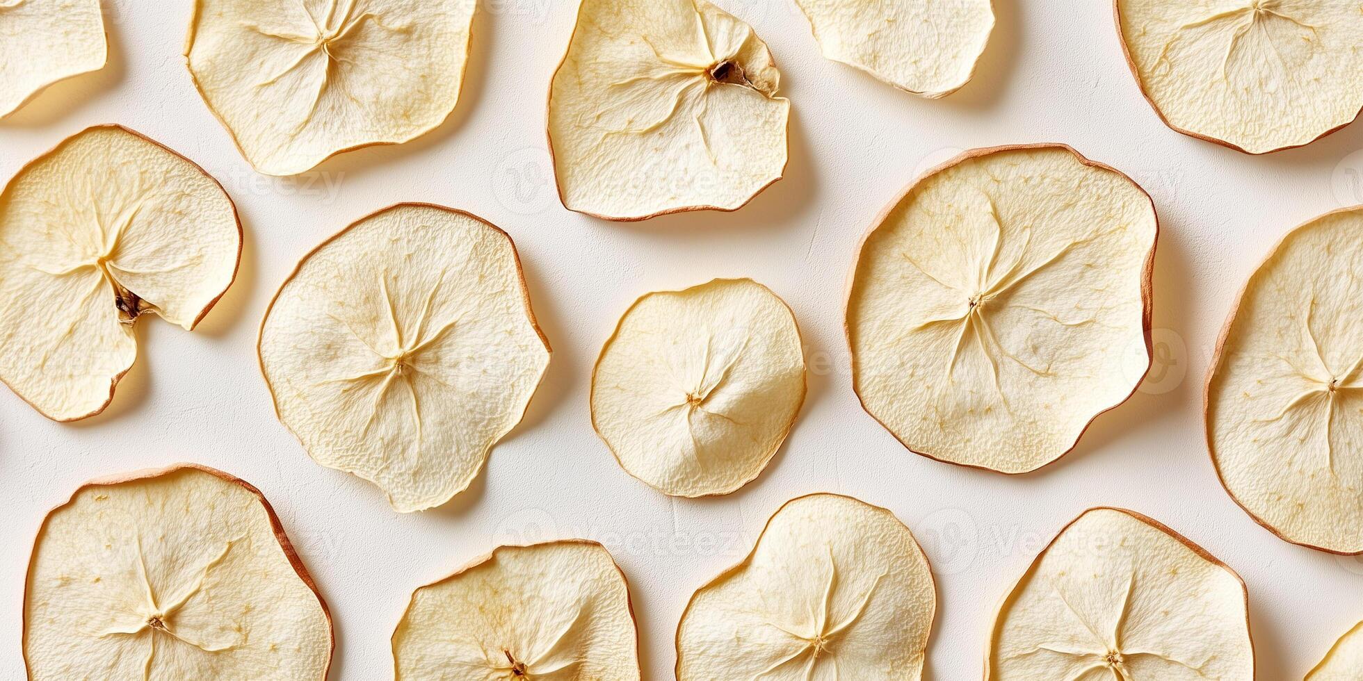 Handful of dried apple slices in a slightly irregular pattern, culinary photography photo
