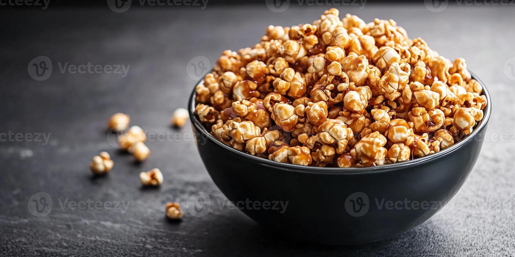 Large bowl of caramel corn, with coated popcorn kernels overflowing, food photography photo