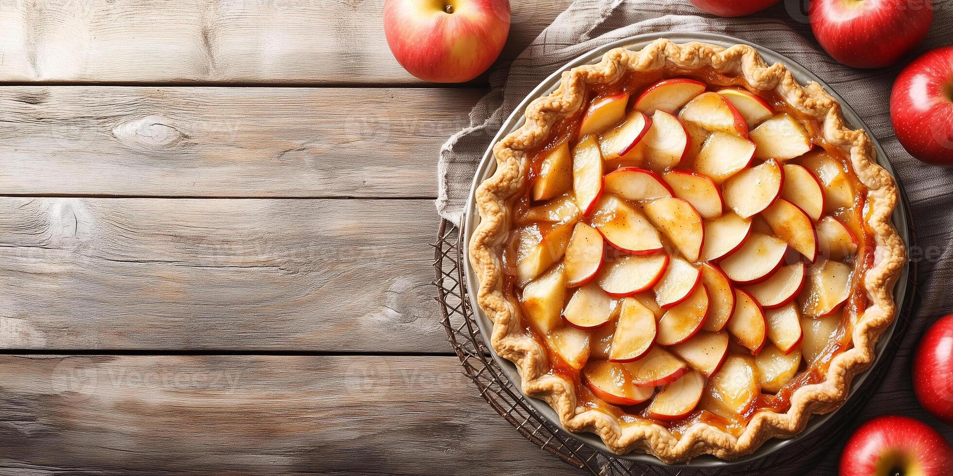 Pie with circular crust, filled with sliced apples, placed on cooling rack, food photography photo