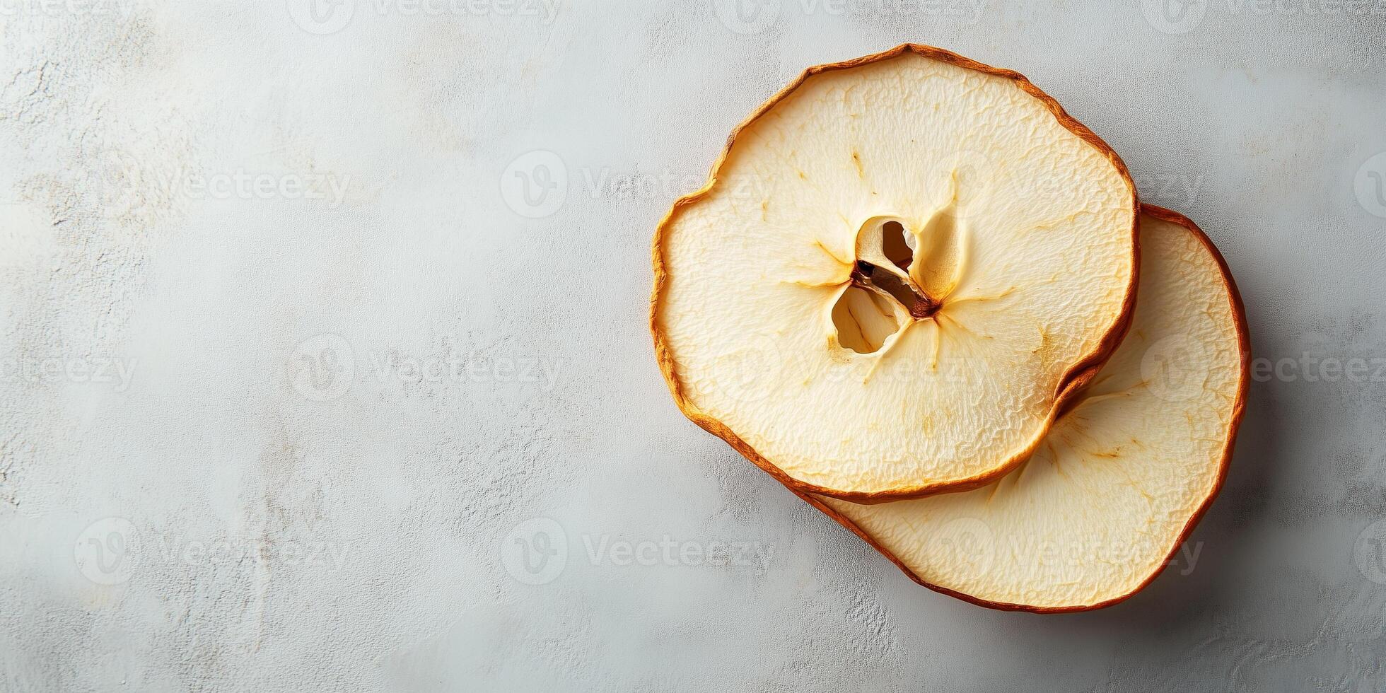 Single dried apple slice resting on another, food photography photo