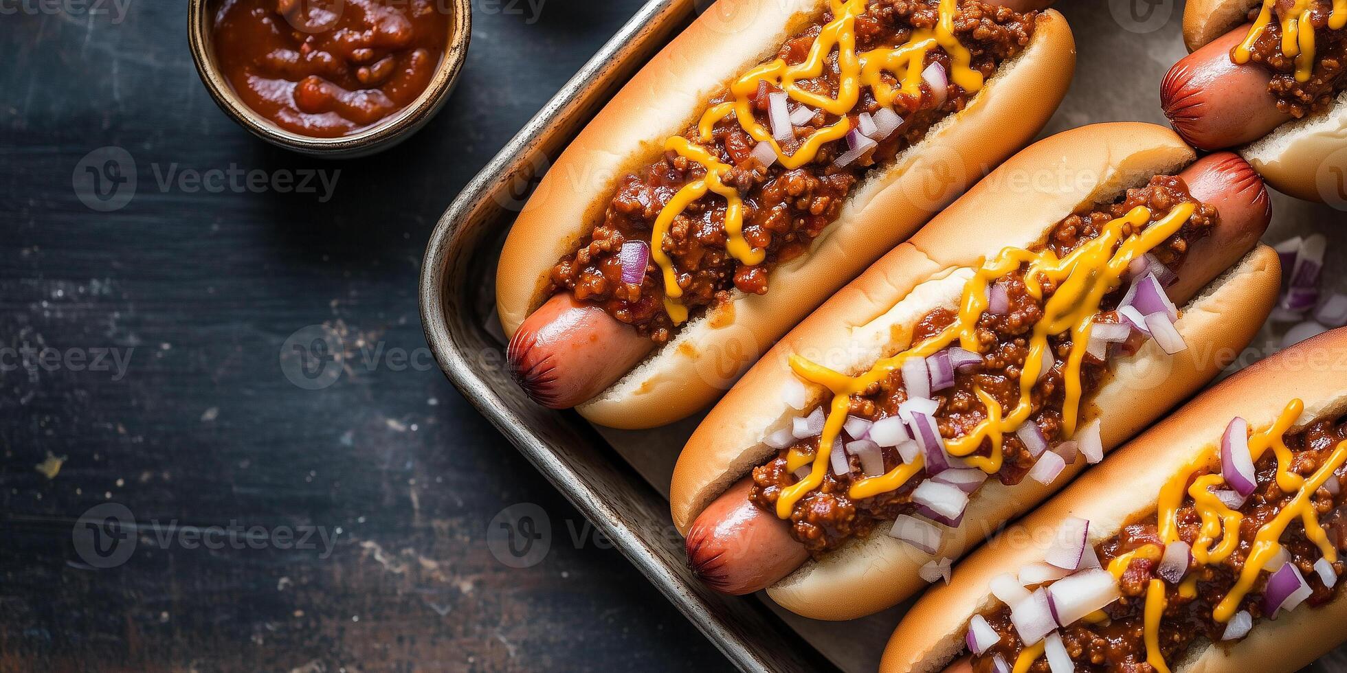 Chili dogs on a metal tray with chili, cheese, and onions, photorealistic food photo