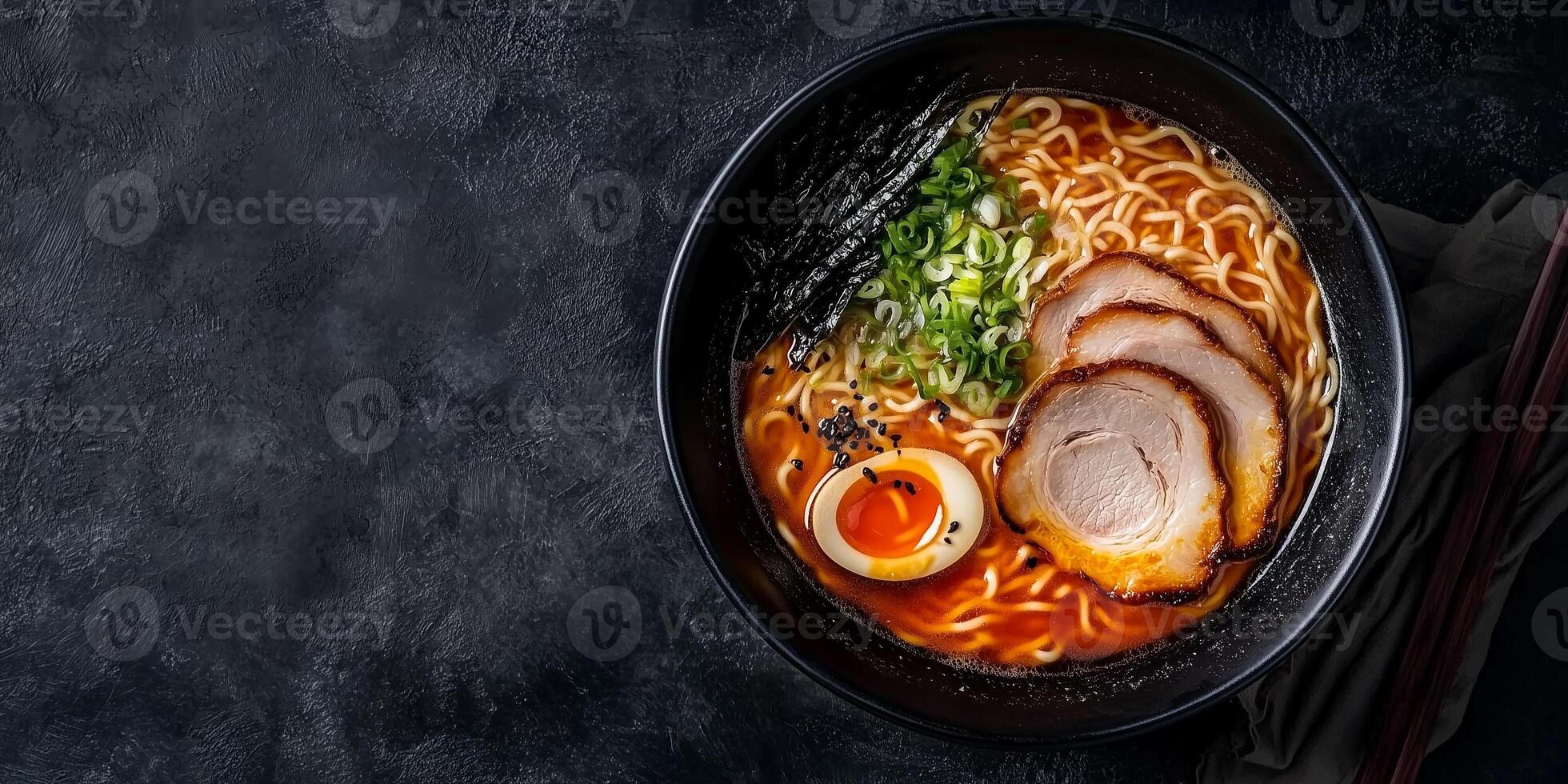 Ramen bowl with thick broth, noodles, and meat slices on a flat surface, food setting photo