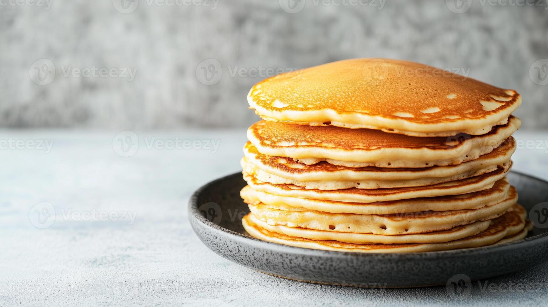 Neatly arranged stack of buttermilk pancakes on a round plate, food setting photo