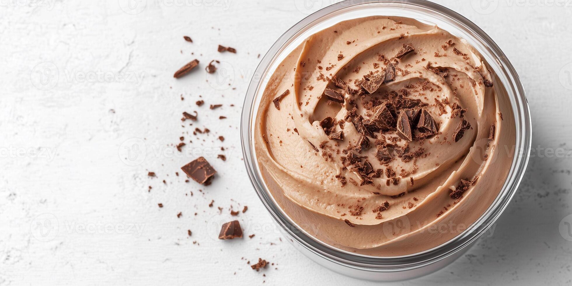 Portion of mousse in a transparent container with no visible garnishes, food setting photo