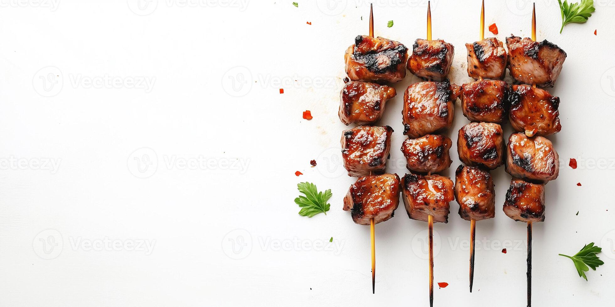 Skewer with small grilled meat pieces, evenly spaced, lying on a flat surface, food setting photo