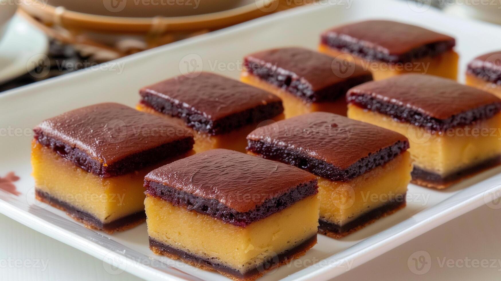 Rectangular red bean cakes with smooth edges and filling on a white platter, food photography photo