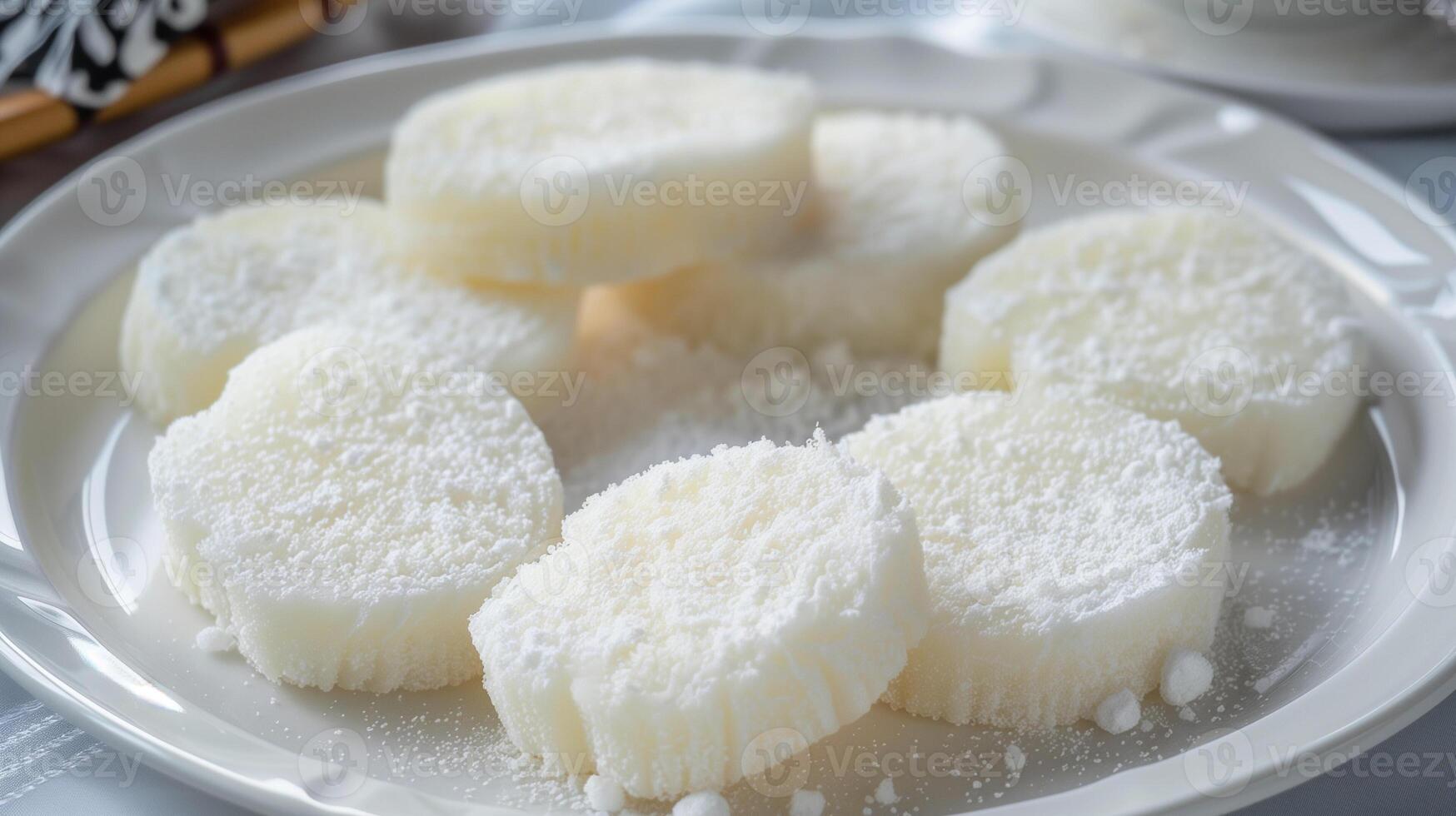 Soft round rice cakes dusted with starch on a clean white plate, food photography photo