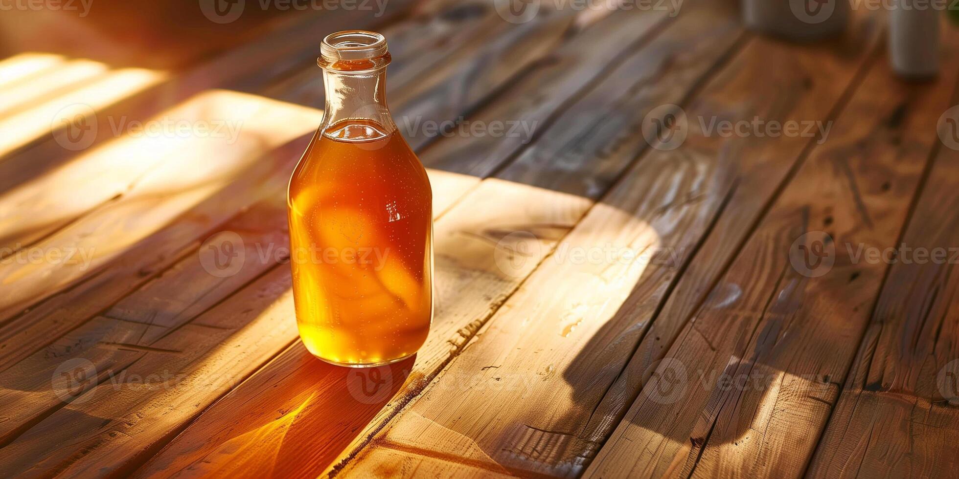 Glass bottle of pear cider, filled halfway, positioned on a smooth wooden table, with sunlight streaming in, gastronomy photography photo