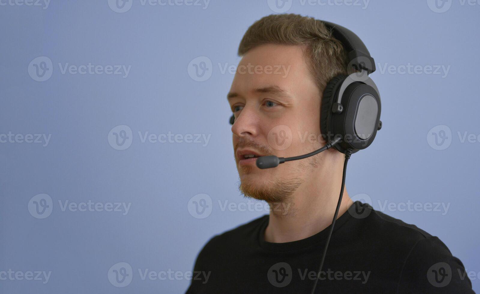 Man working with headphones and microphone. Support service operator talking with a client. Call center telemarketing and customer support conception photo