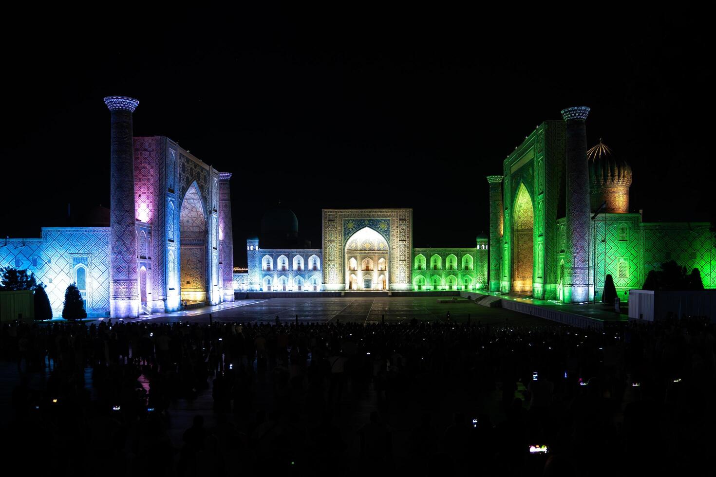 Samarkand, Uzbekistan-august 12, 2023-People in Registan Square watching a light show that illuminates all the buildings in the square during a summer night photo