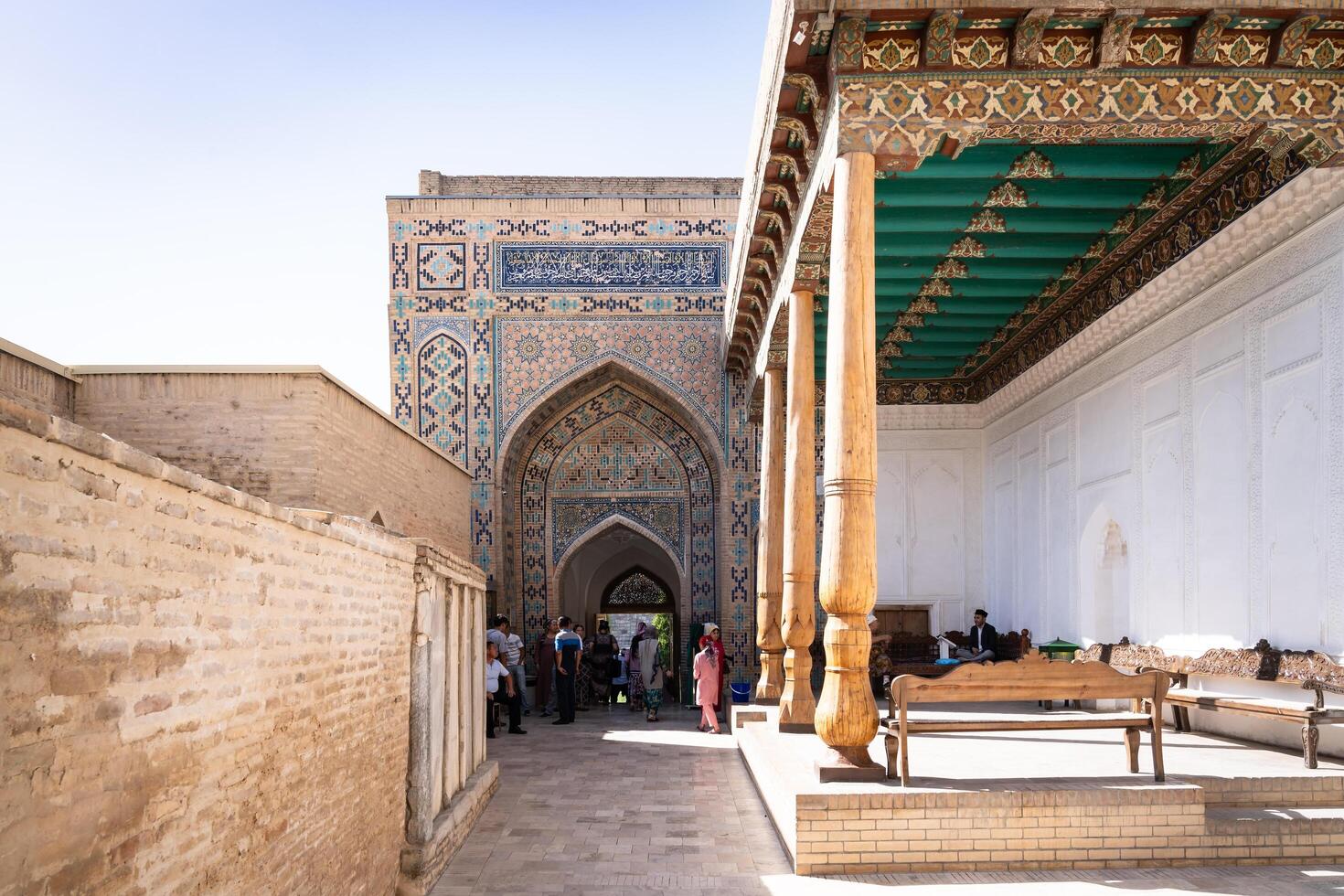 Samarkand, Uzbekistan-august 13, 2023-People visit Shakhi Zinda necropolis, a famous mausoleum complex in Samarkand during a sunny day photo
