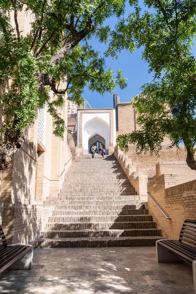 Samarkand, Uzbekistan-august 13, 2023-People visit Shakhi Zinda necropolis, a famous mausoleum complex in Samarkand during a sunny day photo