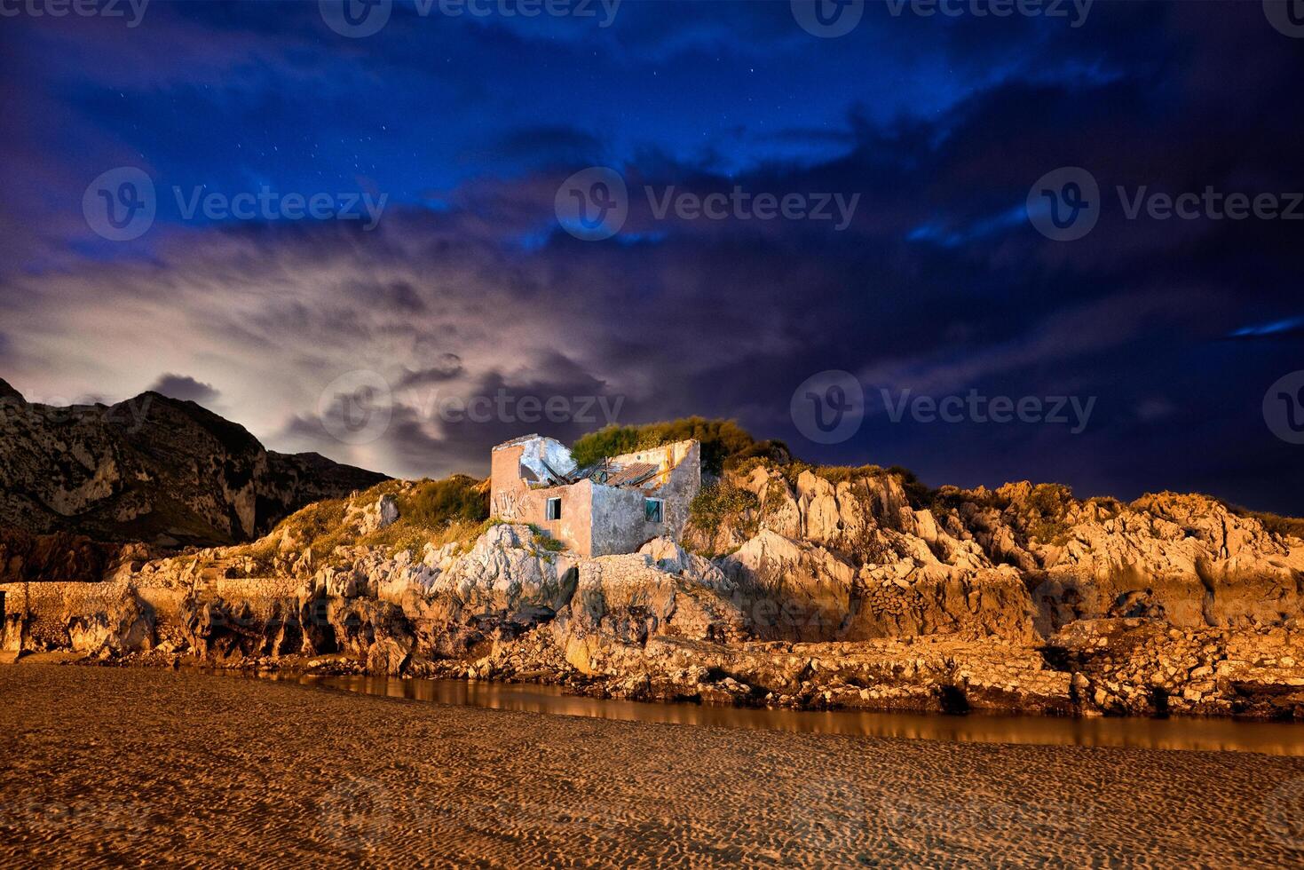 Long exposure of a rock wall with ancient construction in a small lake at dusk with striking color photo