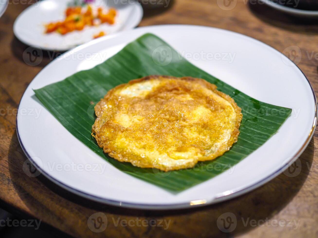 Omelet served with banana leaves as a base photo
