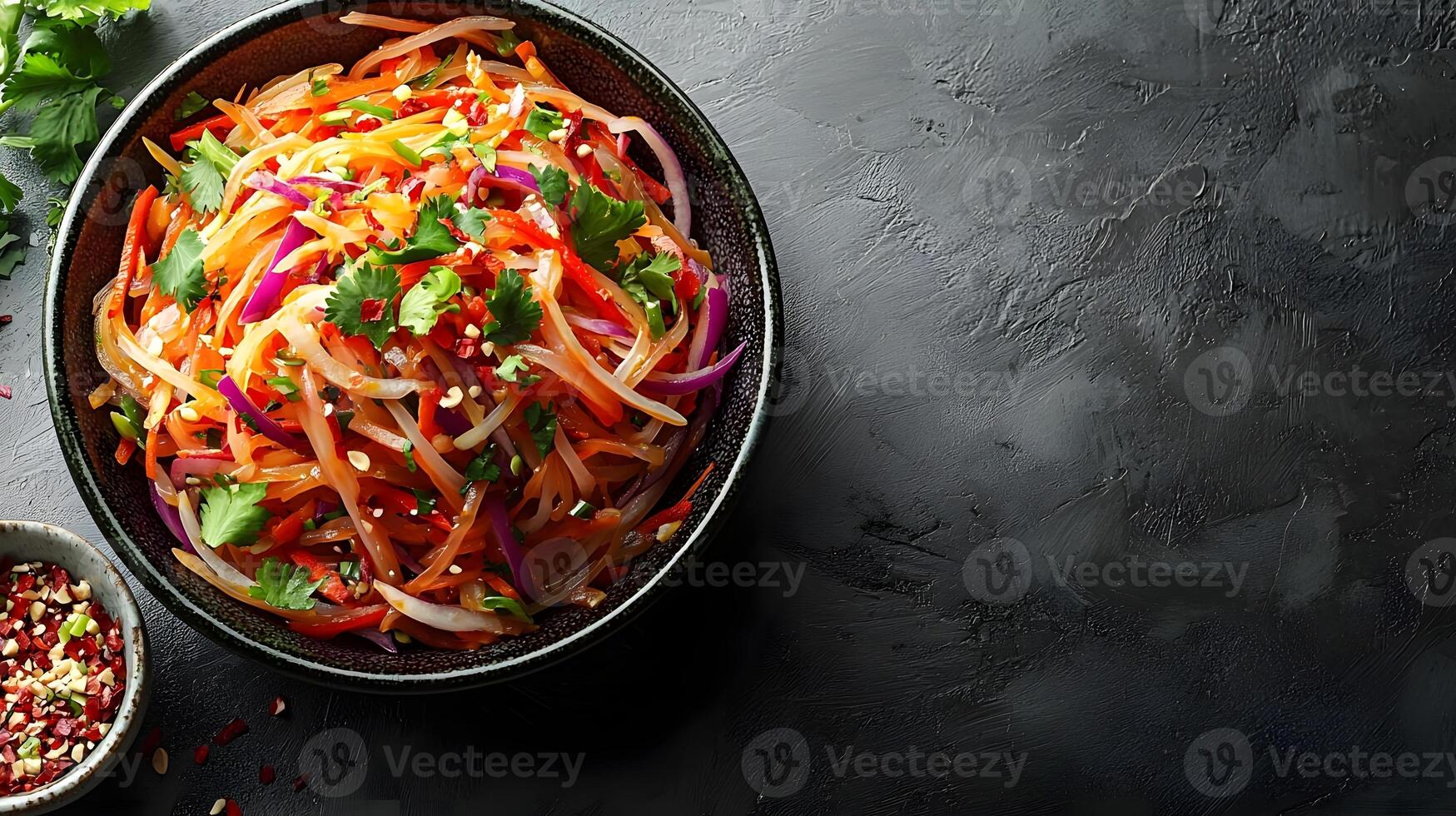 Vibrant Fresh Vegetable Salad with Colorful Peppers, Carrots, and Fresh Herbs Served in a Stylish Bowl on Dark Slate Background photo