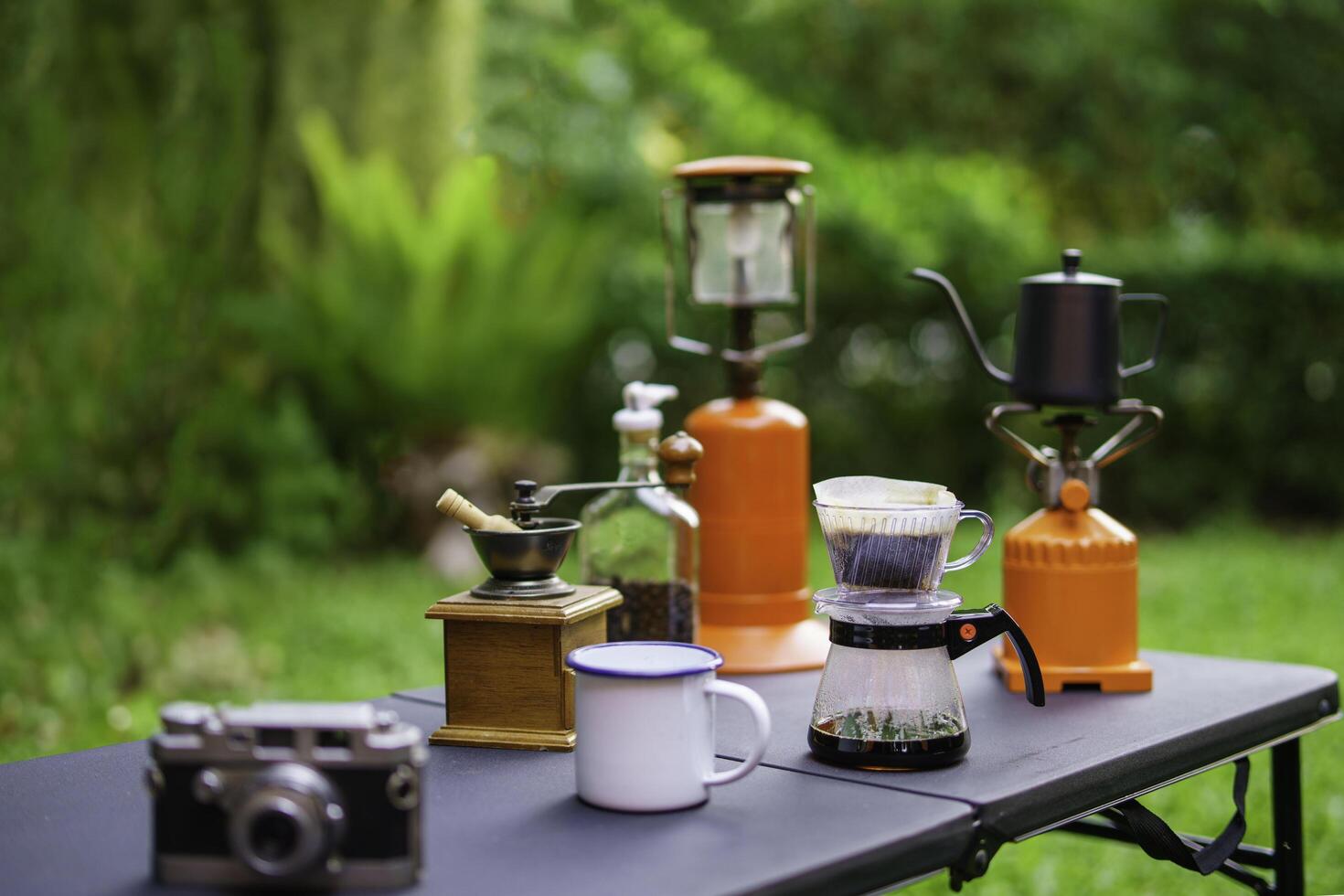 Drip coffee brewing while outdoor camping, outdoor coffee-making facilities, soft focus photo
