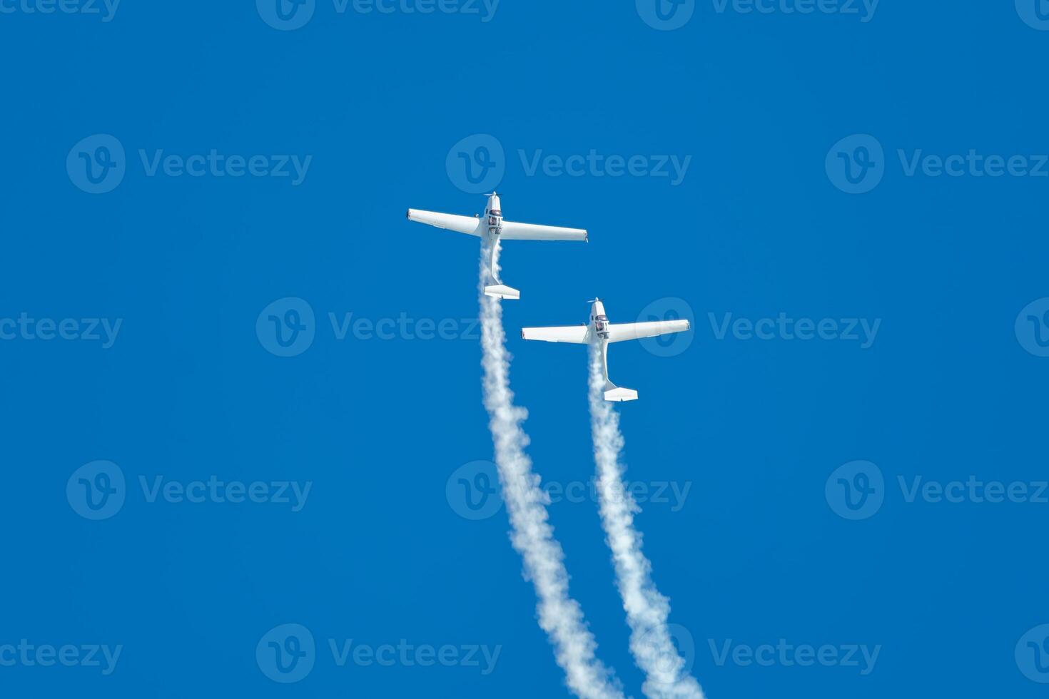 Stunt aerobatic plane performing stunts in air photo