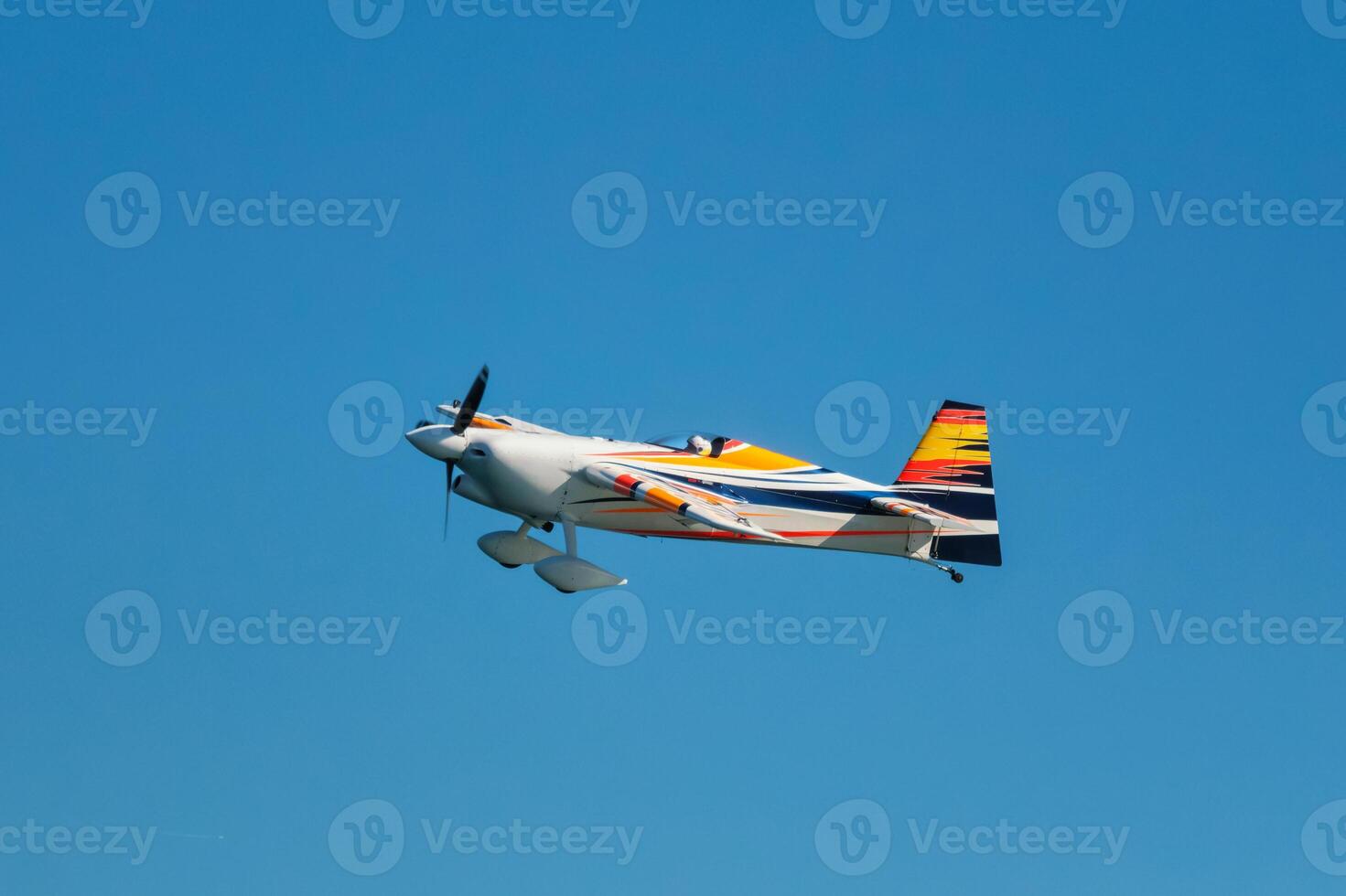 Stunt aerobatic plane performing stunts in air photo