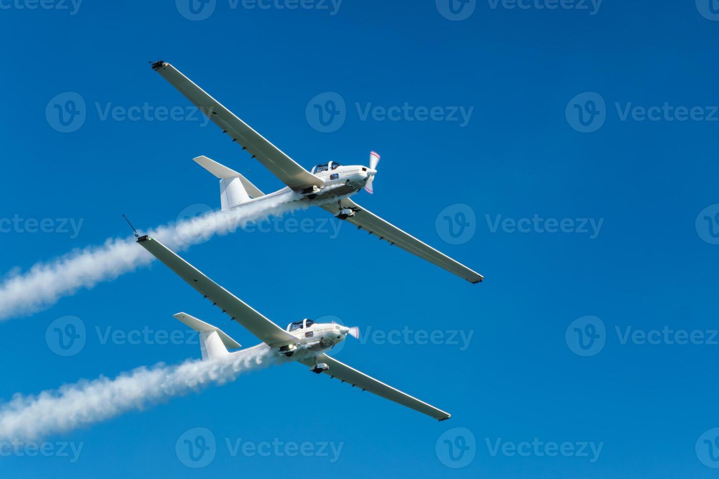 Stunt aerobatic plane performing stunts in air photo