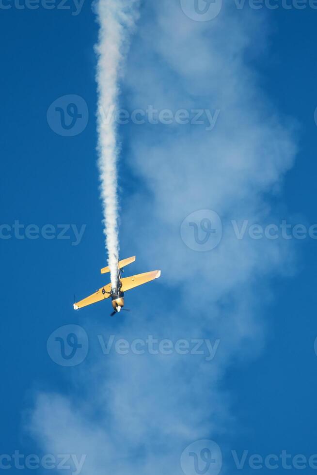 Stunt aerobatic plane performing stunts in air photo