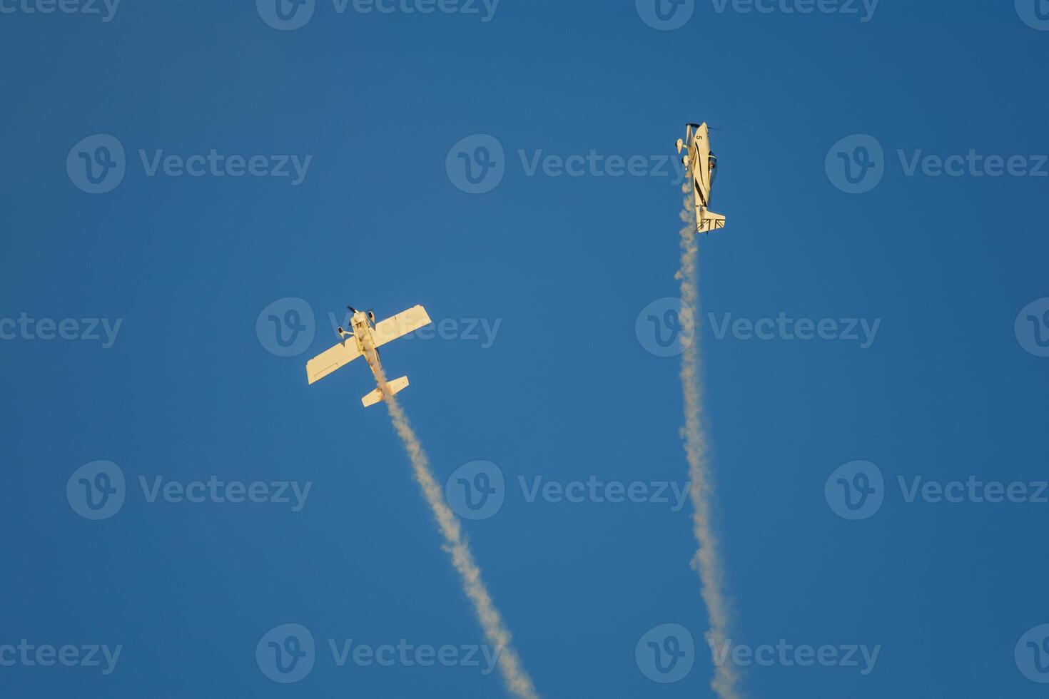 Stunt aerobatic plane performing stunts in air photo