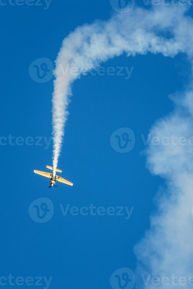 Stunt aerobatic plane performing stunts in air photo