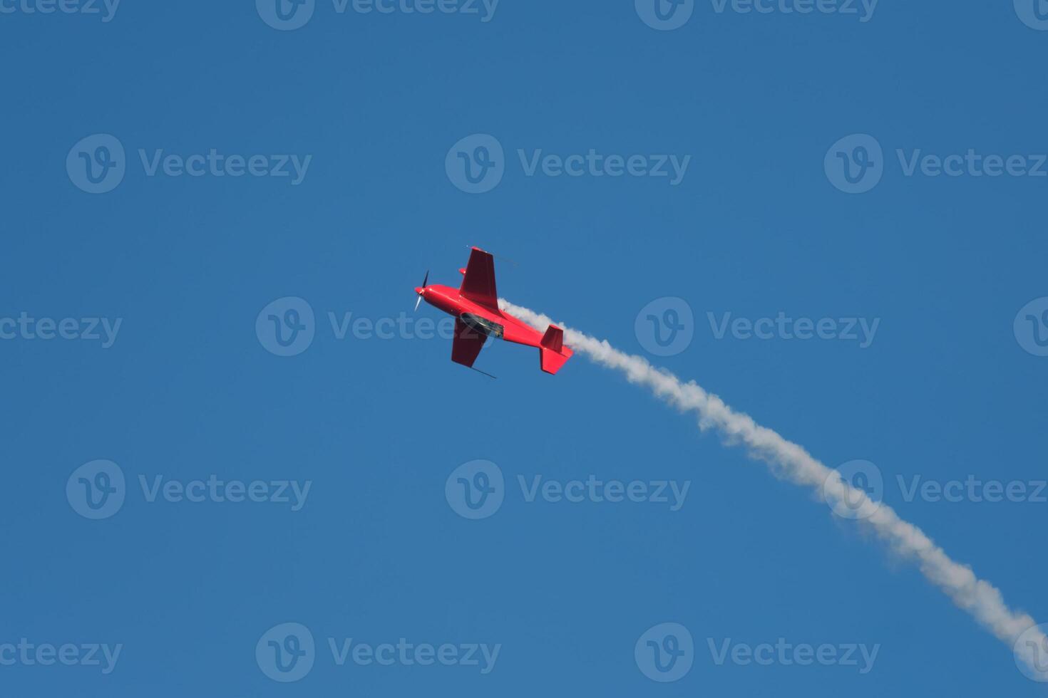 Stunt aerobatic plane performing stunts in air photo