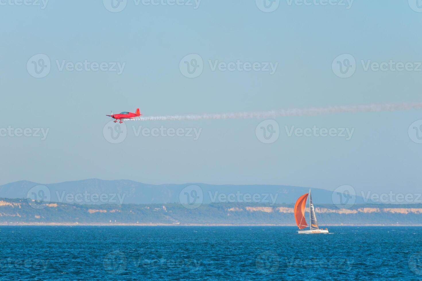 Stunt aerobatic plane performing stunts in air photo
