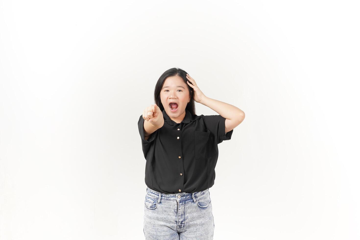 beautiful Asian woman shows a shocked expression, pointing outward while holding her head in surprise against a white background. photo