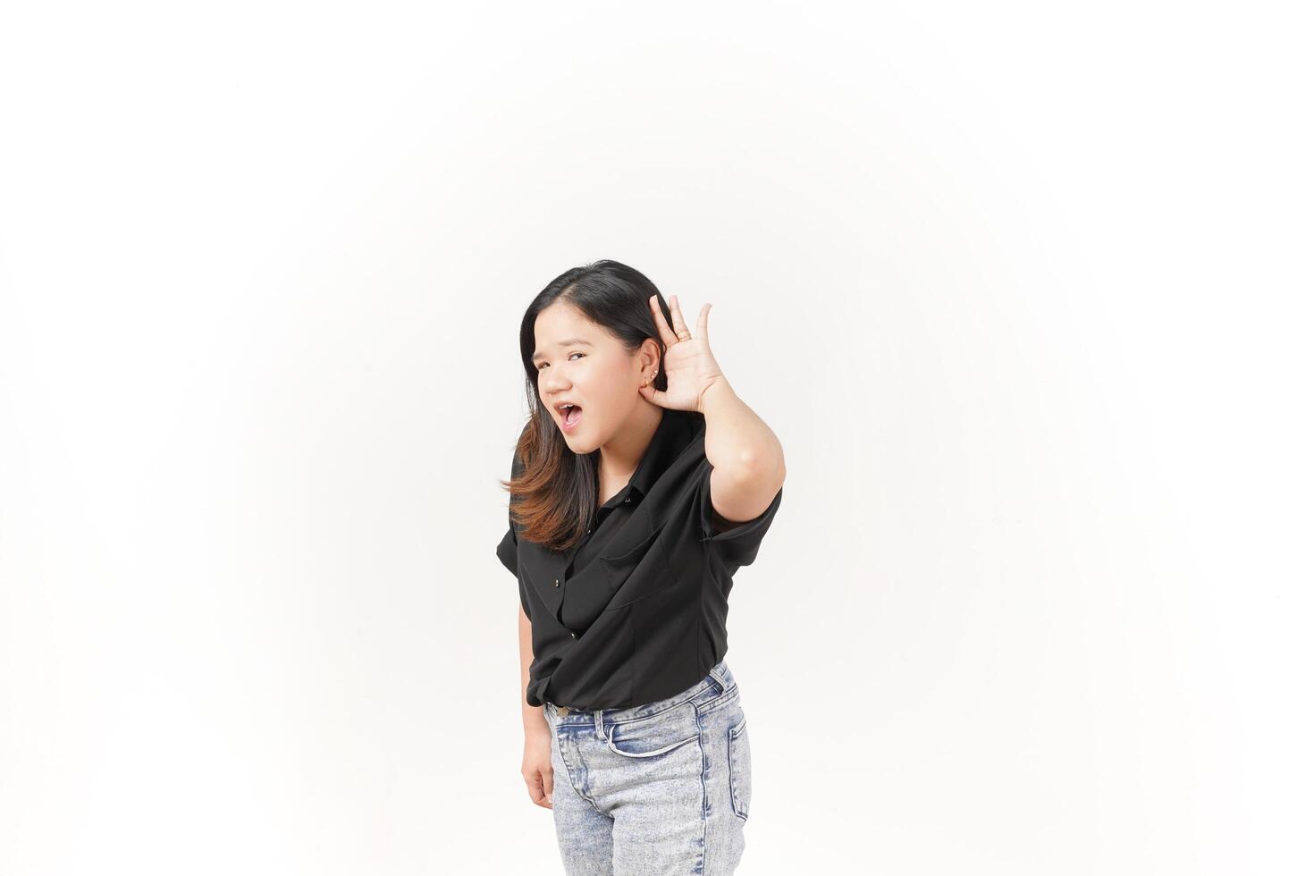 beautiful Asian woman poses with her hands on both ears, trying to listen attentively against a white background photo