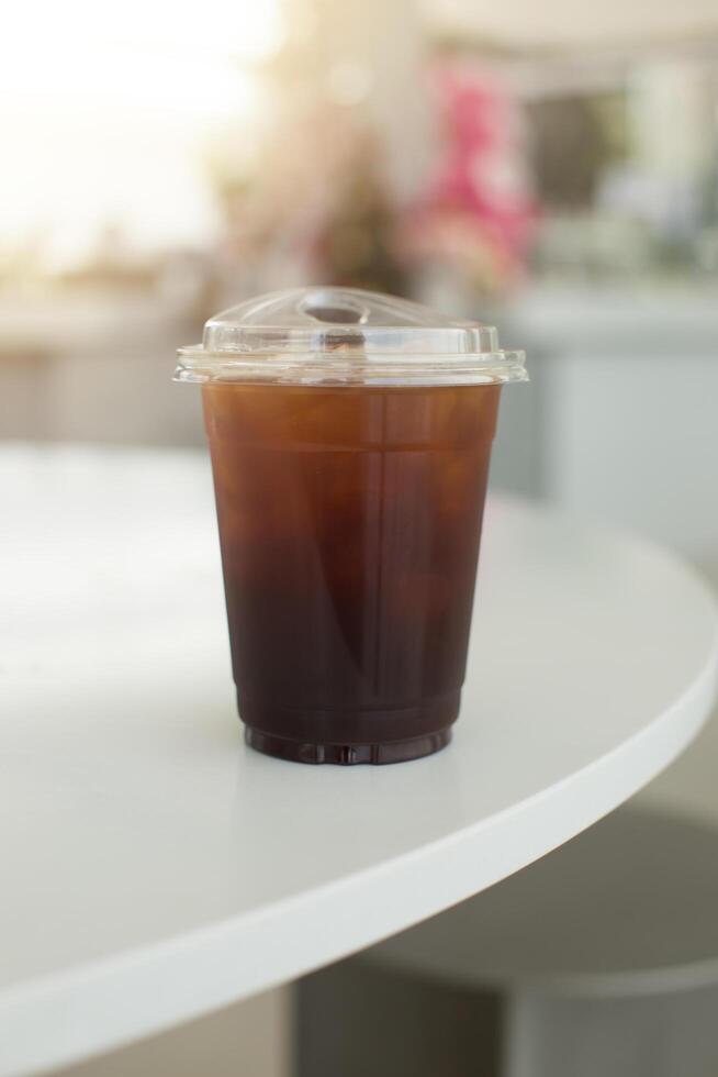 An iced Americano sits on a table, capturing the essence of a refreshing summer beverage. photo