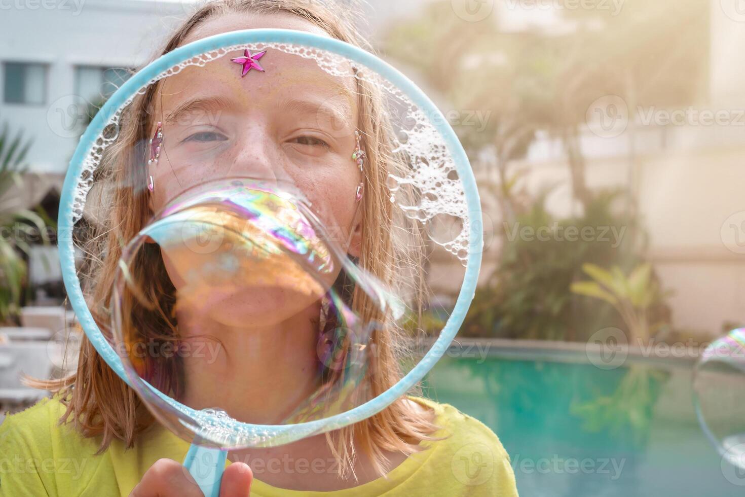 Child blowing soap bubbles photo