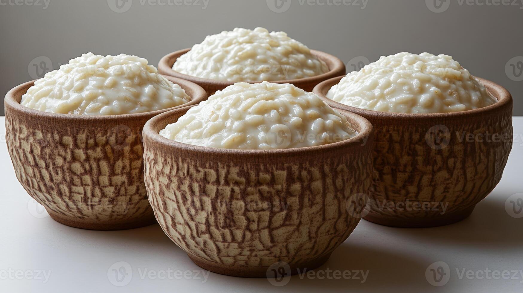 Delicious rice pudding is presented in unique, rustic bowls, inviting a sweet treat photo