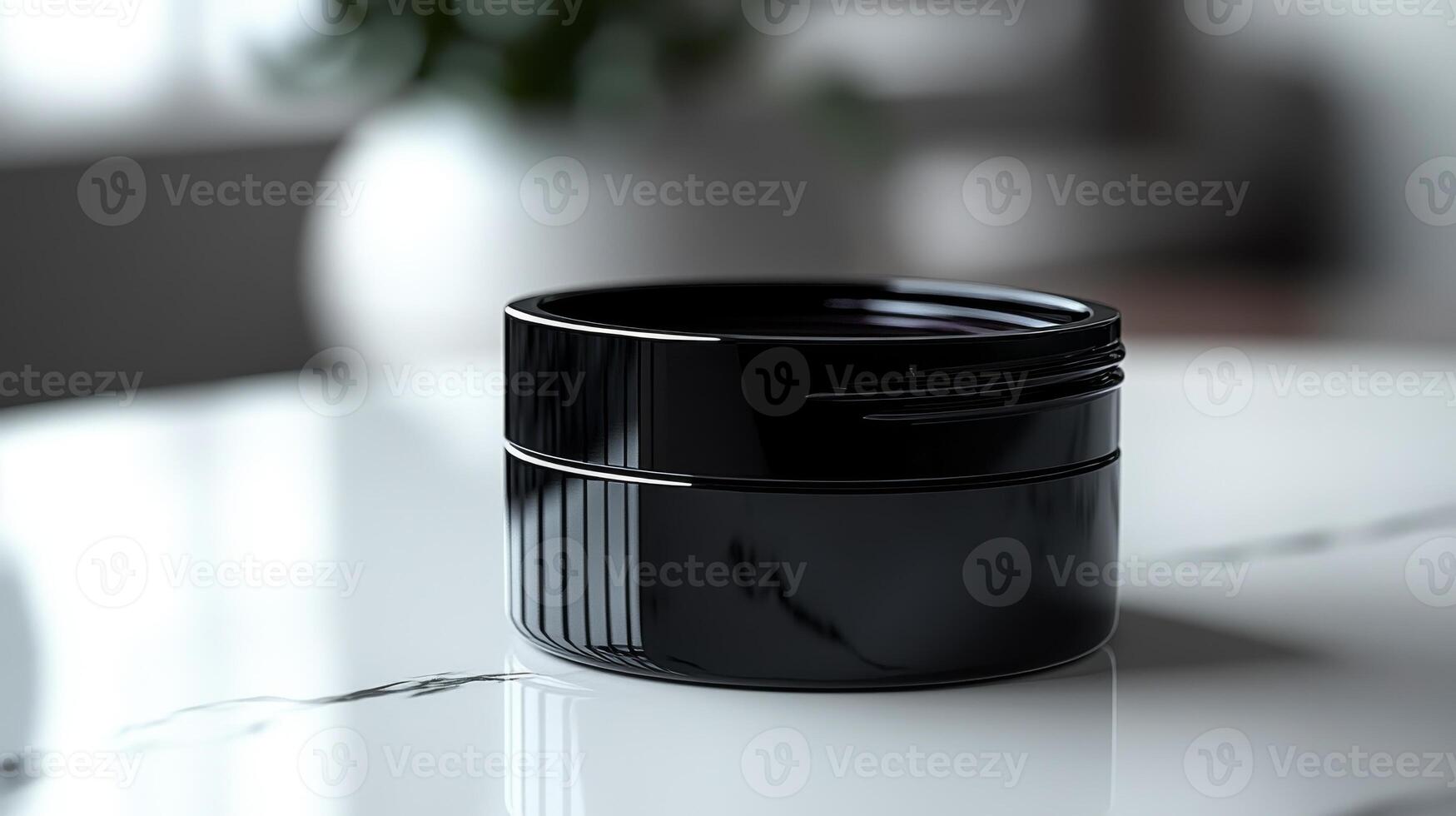 A stylish black container rests elegantly on a marble table with soft lighting, capturing a moment of minimalistic beauty and modern design photo