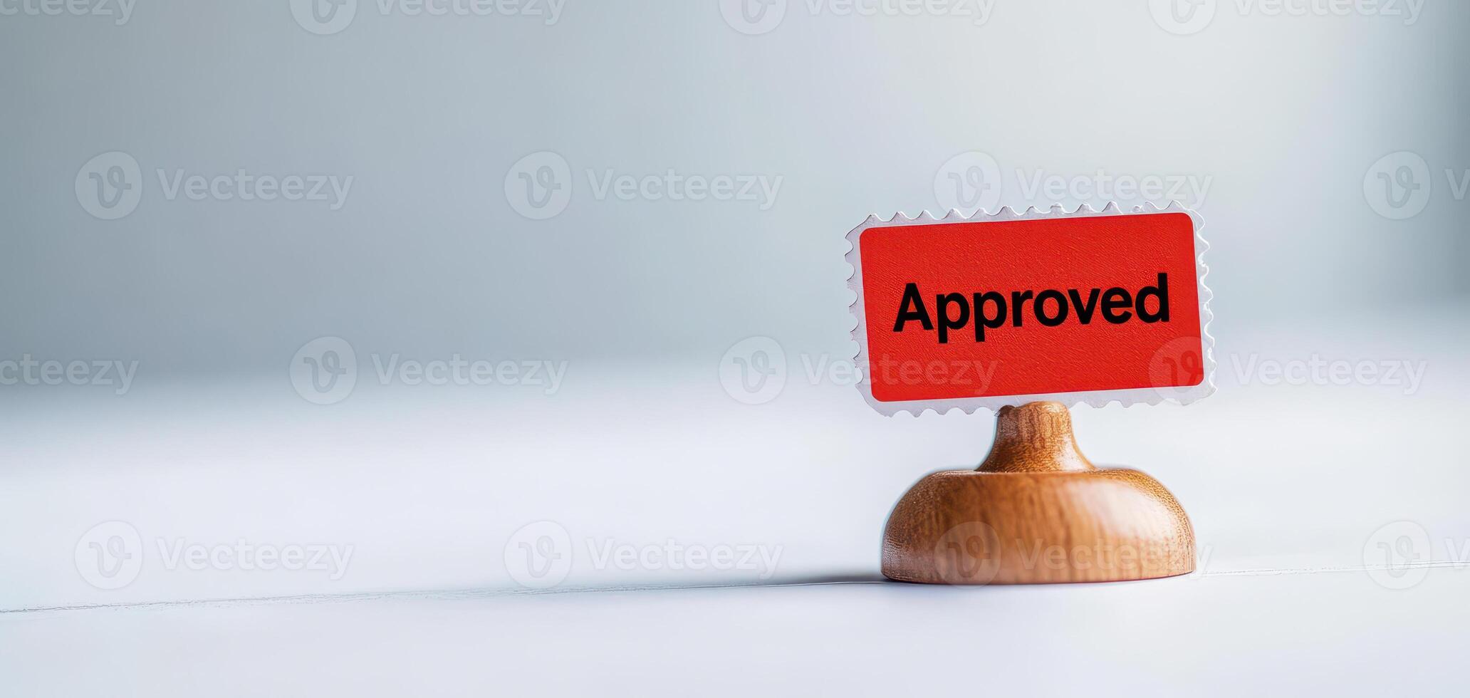 Approved stamp on wooden base signifies acceptance and validation, perfect for documents and forms. This conveys sense of completion and assurance photo