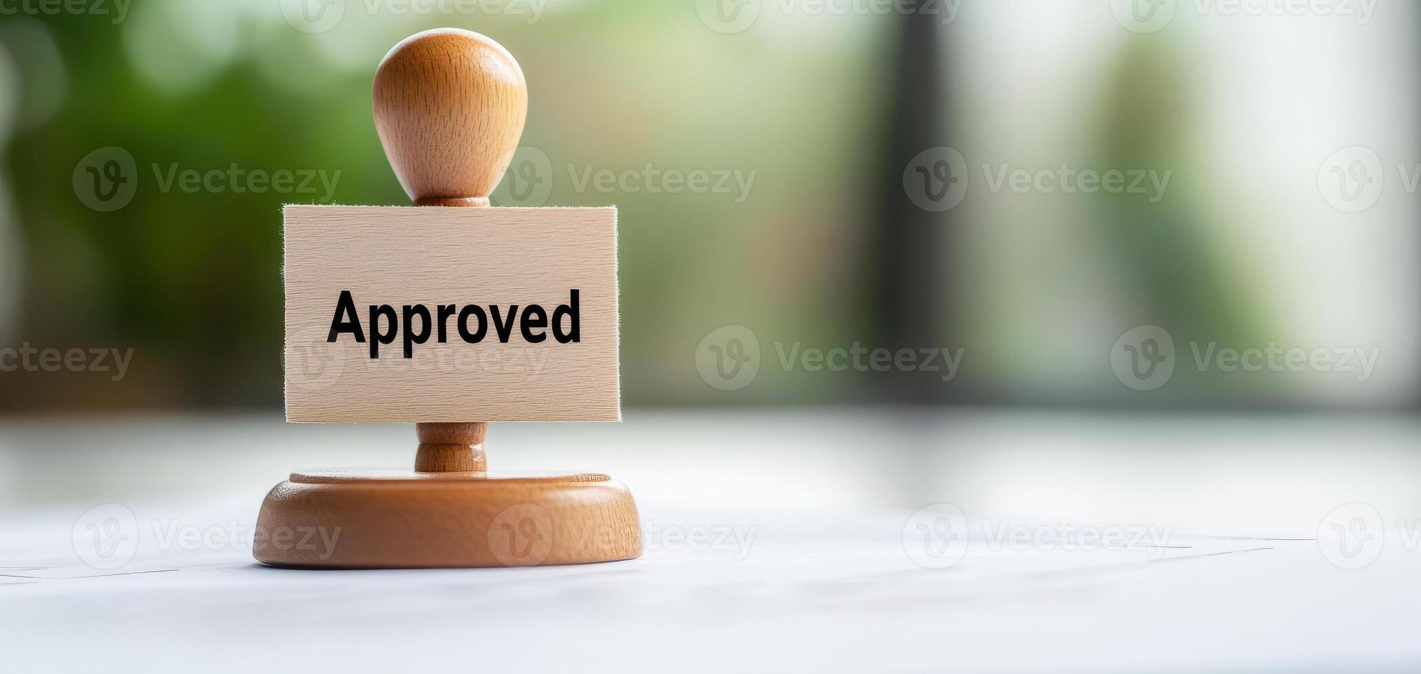 Approved stamp on wooden base signifies validation and acceptance, often used in official documents and processes photo