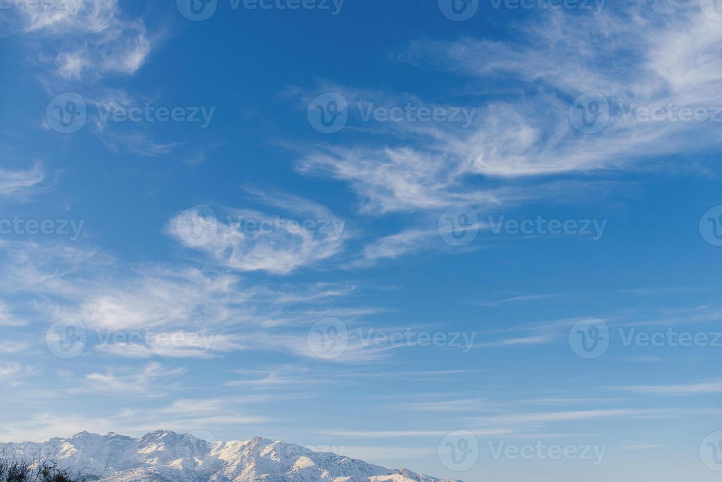 Beautiful clouds over the Tien Shan mountains in winter in Uzbekistan photo
