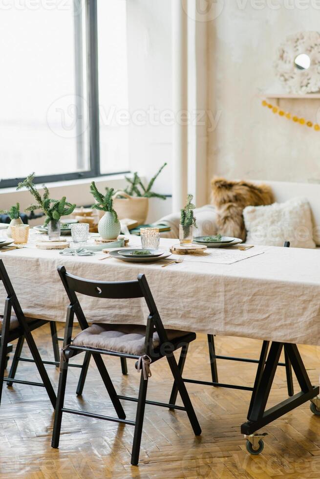 Scandinavian comfort in the dining room on Christmas eve. Festive table setting photo