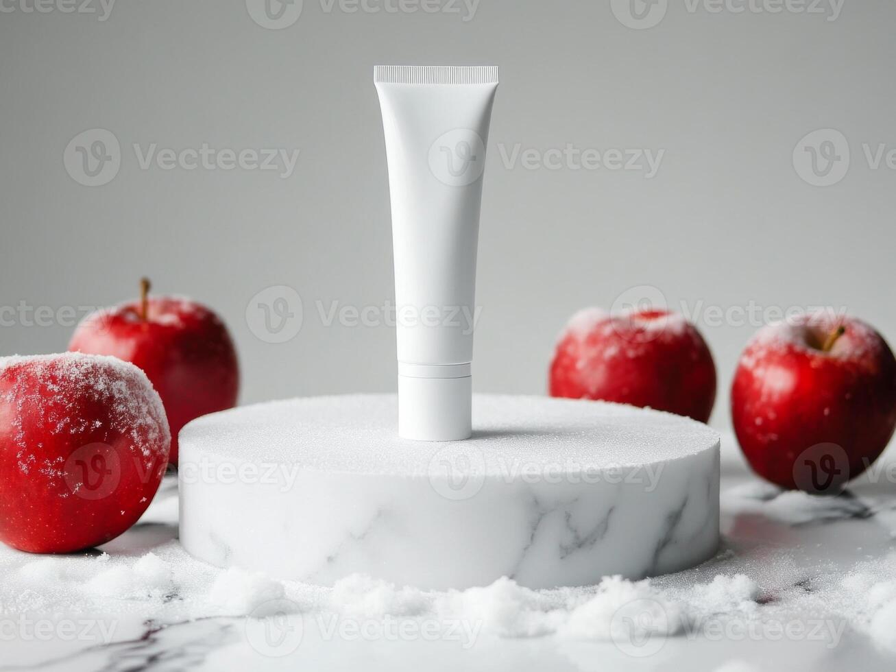 White cosmetics cream tube on white podium standing on marble table. Snow and red apples on background. Minimalistic photo style