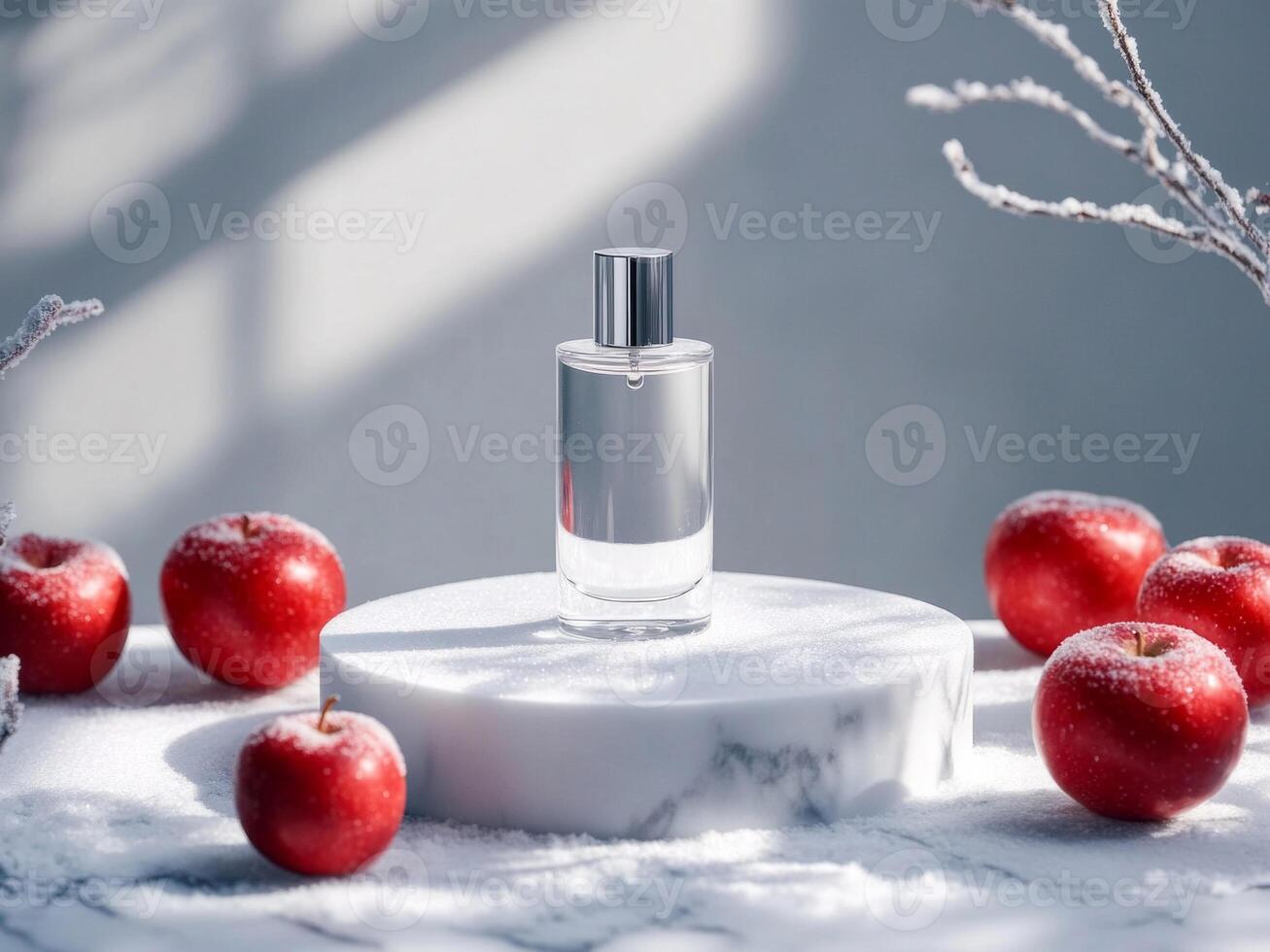 Transparent perfume bottle on white podium on marble table. Snow and frosty red apples around. Minimalistic photo style.