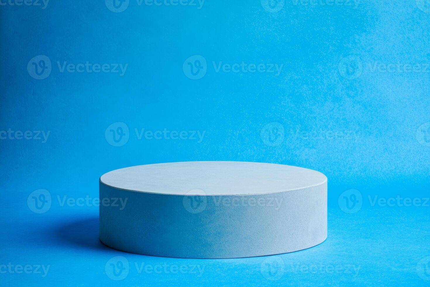 White rounded podium on a bright blue background. Minimalistic photo style.