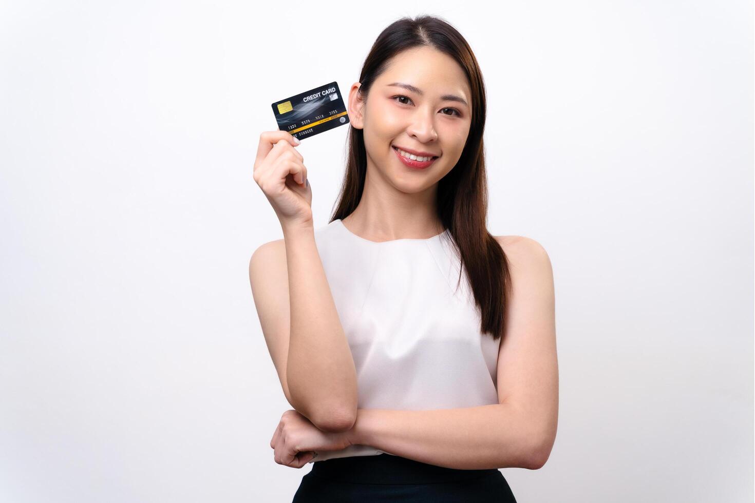 A woman is holding a credit card and smiling. happiness and confidence. Financial concept. photo