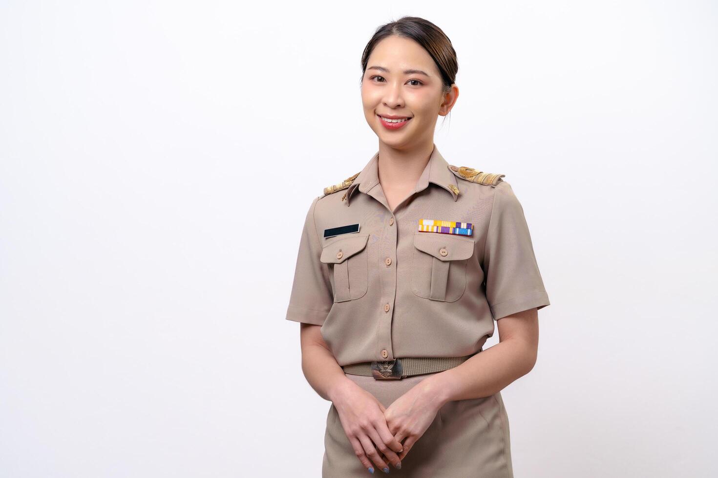 Young Thai Asian Teacher in the uniform standing and smiling to the camera photo